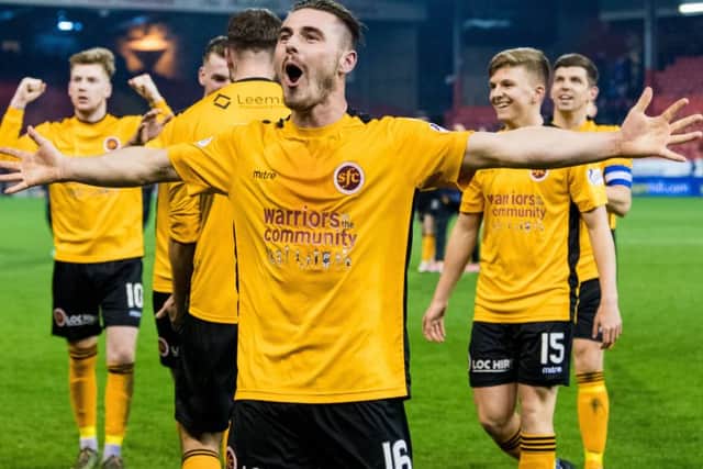 Stenhousemuir's Sean Dickson celebrates with his team-mates at full-time after they secured an unlikely draw. Picture: SNS