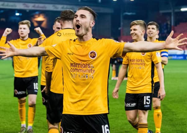 Stenhousemuir's Sean Dickson celebrates with his team-mates at full-time after they secured an unlikely draw. Picture: SNS
