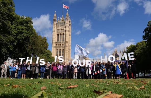 EU citizens hold up a banner after lobbying MPs to guarantee their post-Brexit rights at the Houses of Parliament in London. Picture: PA