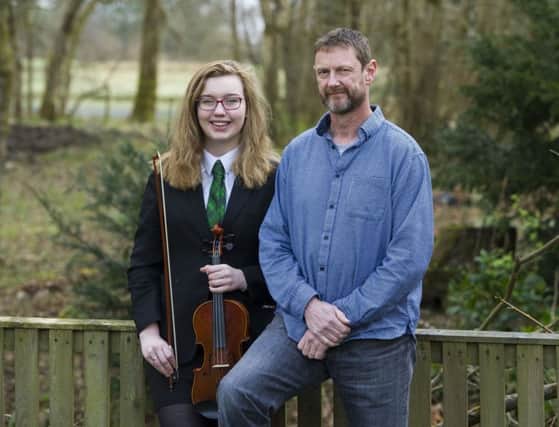 Dave Gornall with his daughter, Abby, who learned violin at school along with her brother