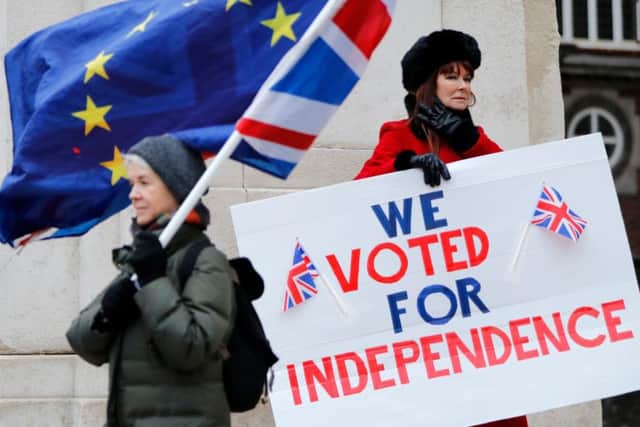 A pro-EU campaigner and a pro-Brexit one demonstrate outside the Houses of Parliament (Picture: Tolga Akmen/AFP/Getty)