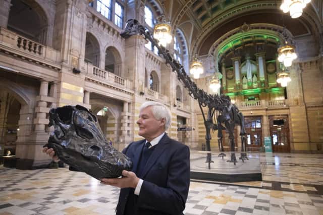 William Thomson, great grandson of Andrew Carnegie, with a plastic replica of the skull of Dippy, the Natural History Museum famous diplodocus skeleton, as it was unveiled at Kelvingrove. Picture: PA