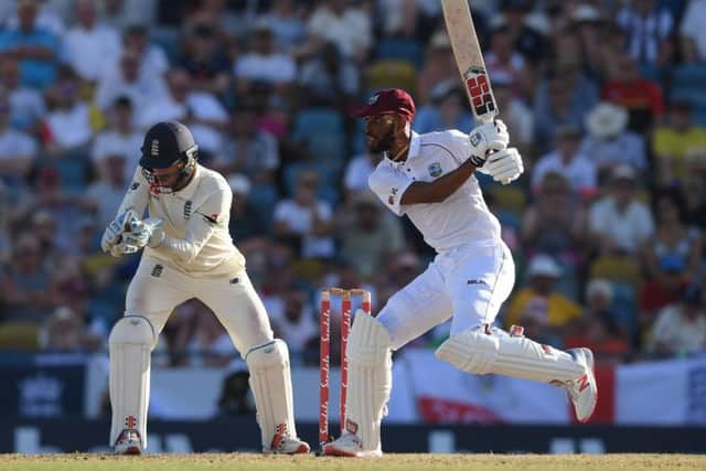 West Indies batsman Roston Chase plays a shot as England wicketkeeper Ben Foakes looks on at the Kensington Oval in Barbados. Picture: Shaun Botterill/Getty