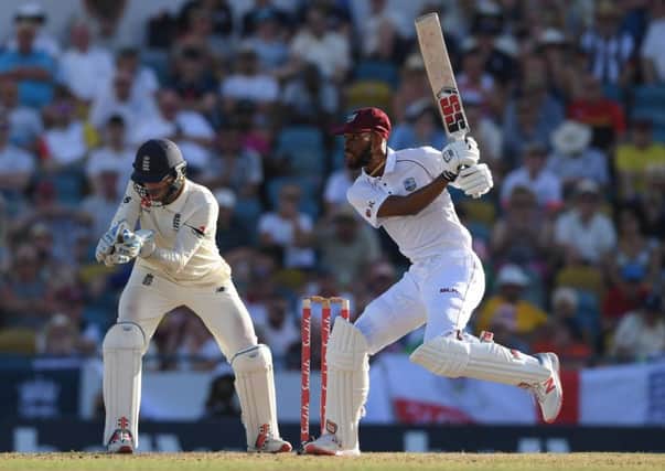 West Indies batsman Roston Chase plays a shot as England wicketkeeper Ben Foakes looks on at the Kensington Oval in Barbados. Picture: Shaun Botterill/Getty