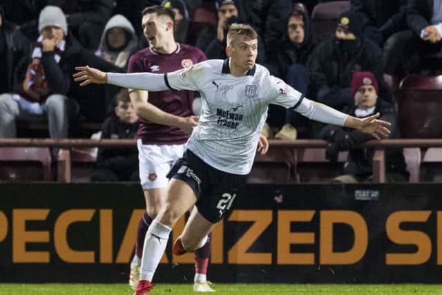Andrew Nelson celebrates scoring the winner on his debut as Dundee moved off the bottom spot. Picture: SNS Group