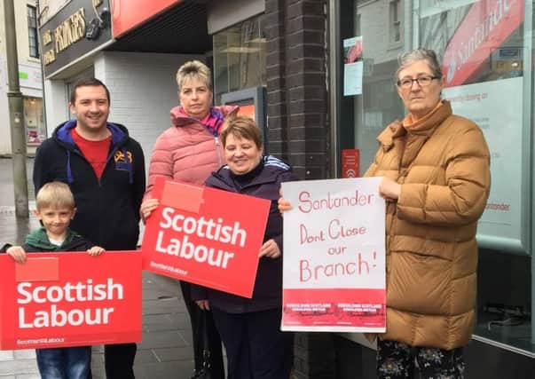 Claudia Beamish MSP  (far right) outside the  Lanark Santander branch earmarked  for closure