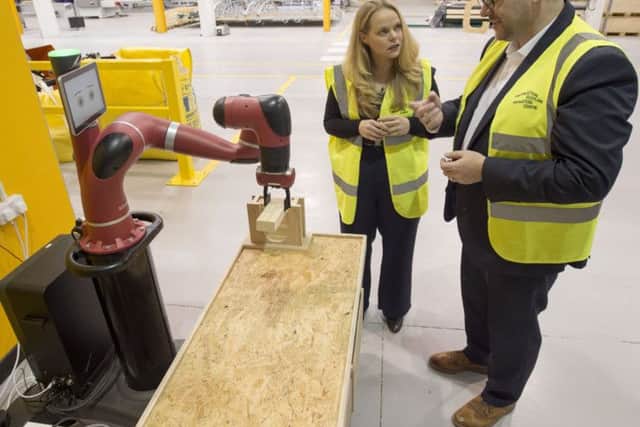 Sarah Beale is shown around by CSIC's Stephen Good during a tour of the facility. Picture: PA