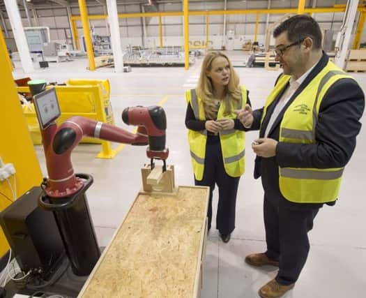 Sarah Beale is shown around by CSIC's Stephen Good during a tour of the facility. Picture: PA