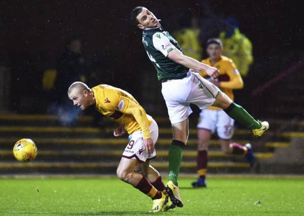 Paul Hanlon in action against Motherwell's Curtis Main. Picture: Rob Casey/SNS