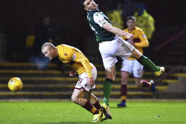 Paul Hanlon in action against Motherwell's Curtis Main. Picture: Rob Casey/SNS