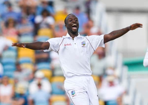 West Indies paceman Kemar Roach celebrates the dismissal of England's Jos Buttler. Picture: Randy Brooks/AFP/Getty