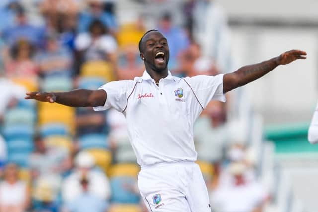 West Indies paceman Kemar Roach celebrates the dismissal of England's Jos Buttler. Picture: Randy Brooks/AFP/Getty
