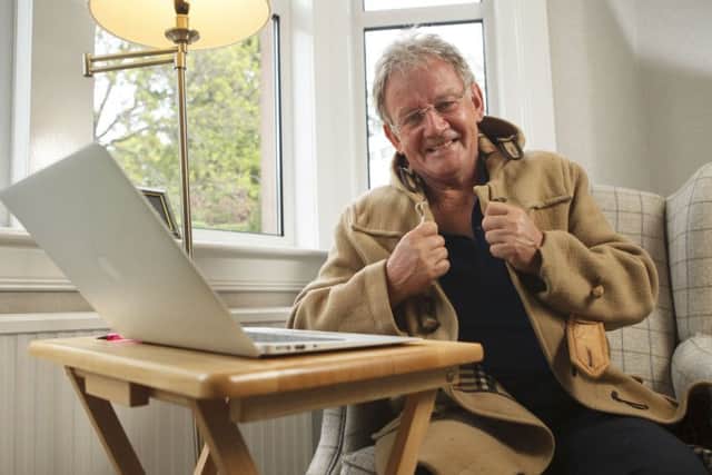 Terry Christie at home with his trademark duffle coat. Picture: Toby Williams