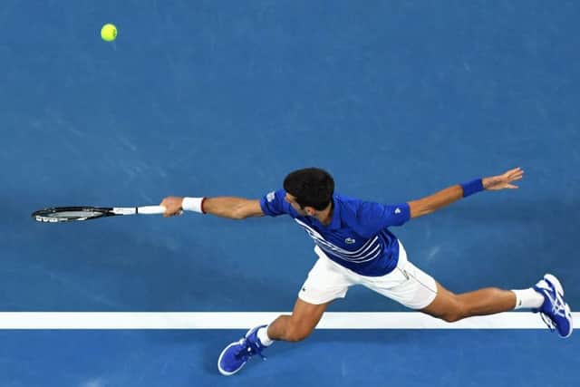 Novak Djokovic hits a return to Lucas Pouille during their men's singles semi-final. Picture: William West/AFP/Getty
