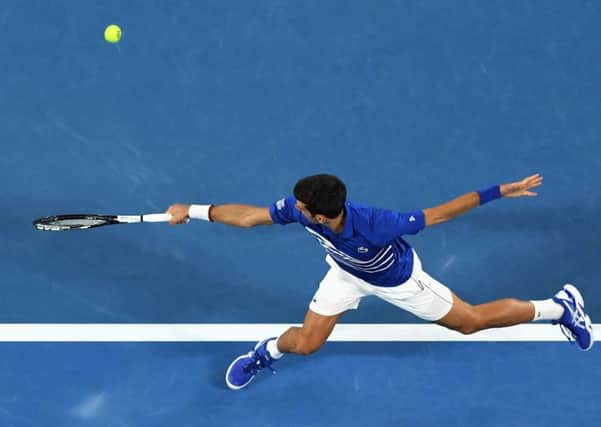 Novak Djokovic hits a return to Lucas Pouille during their men's singles semi-final. Picture: William West/AFP/Getty