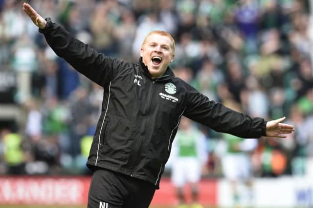 Hibernian manager Neil Lennon celebrates in front of the Rangers fans after his team scored a late equalising goal at Easter Road