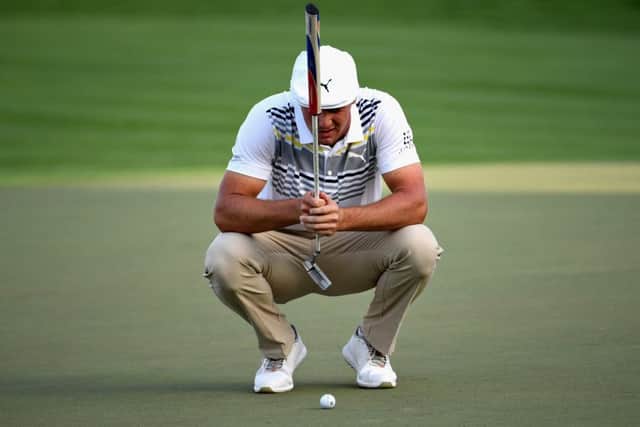 Bryson Dechambeau of United States lines up a putt at the Omega Dubai Desert Classic. Pic: Ross Kinnaird/Getty