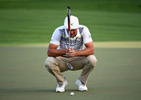 Bryson Dechambeau of United States lines up a putt at the Omega Dubai Desert Classic. Pic: Ross Kinnaird/Getty