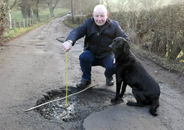 Elliot Henderson and his dog Hoover on the road up to Broomhill, Selkirk. Picture: SWNS