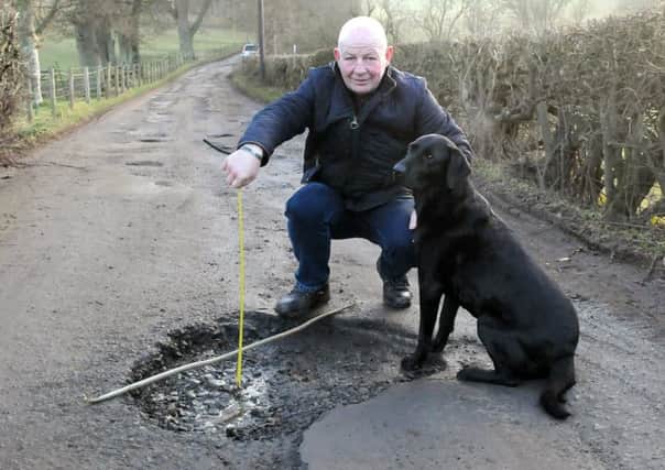 Elliot Henderson and his dog Hoover on the road up to Broomhill, Selkirk.  Picture: SWNS