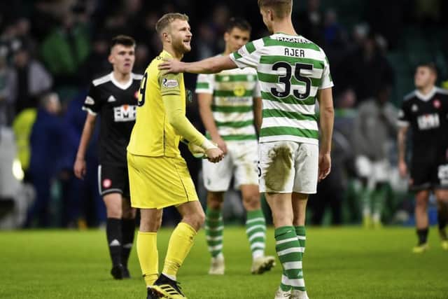 Celtics Kristoffer Ajer and  goalkeeper Scott Bain, who started his third straight game, acknowledge a job well done after securing a clean sheet. Picture: SNS.