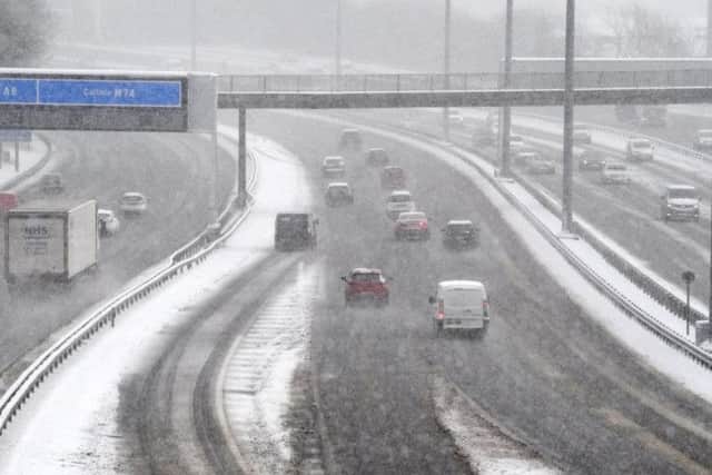 Vehicles drive through snow in Glasgow during poor weather conditions last year.
