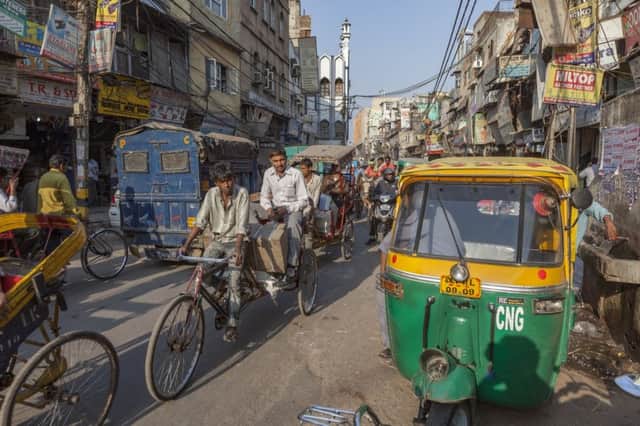 Cargo and people are ferried by rickshaw in Chawri Bazaar, Old Delhi