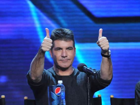 If you think you can get two thumbs up from Simon Cowell, you should audition to become an X Factor contestant (Photo: Shutterstock)