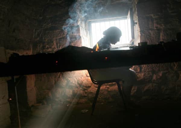 A Jewish woman prays in a cave that contains tombs of holy Jewish rabbis at the ancient cemetery of the northern Israeli city of Safed - a city associated with Jewish mysticism and Kabbalah. PIC: Menahem Kahana / AFP/Getty Images