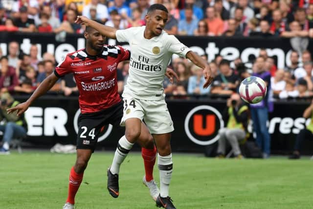 Colin Dagba shields the ball from Guingamp midfielder Marcus Coco during a Ligue 1 match at the Roudourou Stadium. Picture: AFP/Getty Images