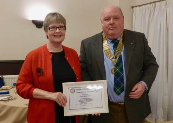 The Rotary Club of Rothesay President Jim Findlay presents a community service award to Jean McMillan. Photo by Ronnie Falconer.