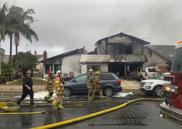 Firefighters respond to the scene of a plane crash at a home in Yorba Linda, California. Picture: AP Photo/Alex Gallardo