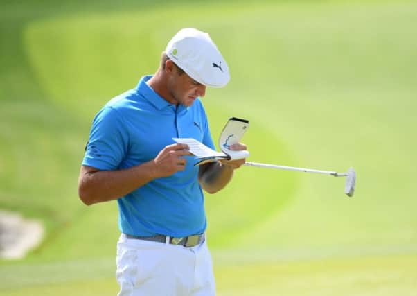 Bryson DeChambeau checks his yardage book during the second round of the Saudi International at Royal Greens. Picture: Getty Images