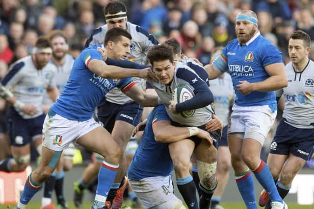 Scotland's Sam Johnson is brought down by Andrea Lovotti. Pic: SNS/Craig Williamson