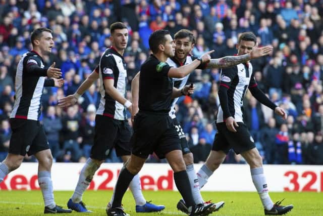 St Mirren players appeal to referee Andrew Dallas after Rangers are awarded their second penalty of the afternoon. Picture: SNS