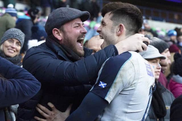 Blair Kinghorn celebrates with a spectator at full time at BT Murrayfield. Picture: SNS/SRU.