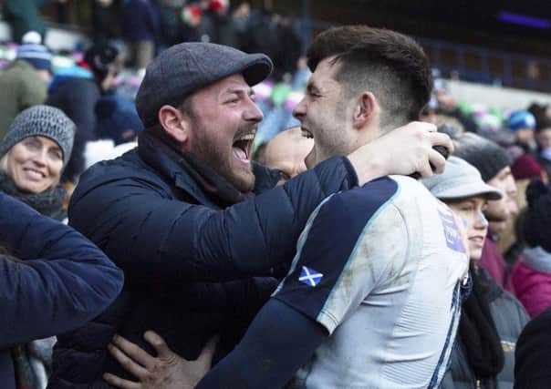 Blair Kinghorn celebrates with a spectator at full time at BT Murrayfield. Picture: SNS/SRU.