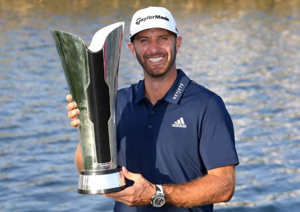 Dustin Johnson celebrates with the trophy after winning the Saudi International. Picture: Getty.