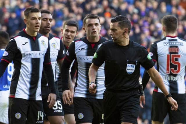 Andrew Dallas is surrounded by St Mirren players after awarding the second of four penalites at Ibrox, Picture: SNS.