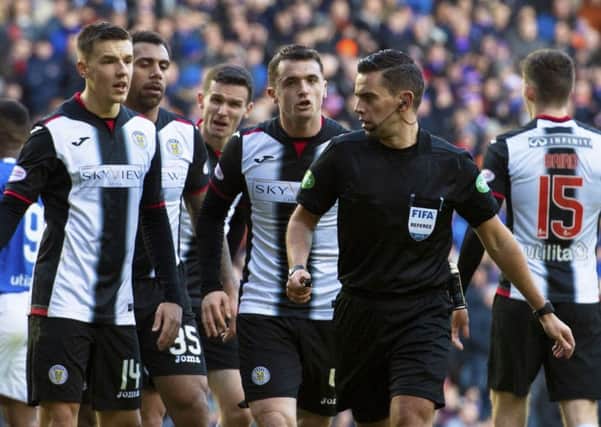 Andrew Dallas is surrounded by St Mirren players after awarding the second of four penalites at Ibrox, Picture: SNS.