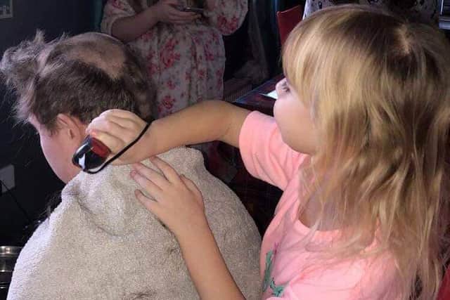 Brendan Bisset, 20, allowed his little sister Charly, 7, shave his hair off after she was diagnosed with acute lymphoblastic leukaemia at the start of the New Year.  Picture: SWNS