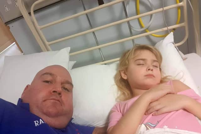 Father Mark Bisset with his daughter Charly in hospital. Picture: SWNS