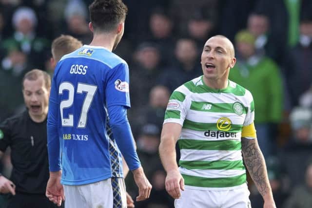 Celtic captain Scott Brown exchanges words with St Johnstone's Sean Goss. Picture: SNS