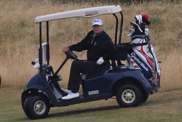 US President Donald Trump drives a golf buggy on his golf course at the Trump Turnberry resort in South Ayrshire last year. Pic: Andrew Milligan/PA Wire