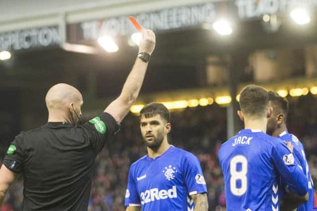 Morelos (far right, partly obscured) receives his marching orders from Bobby Madden. Picture: PA