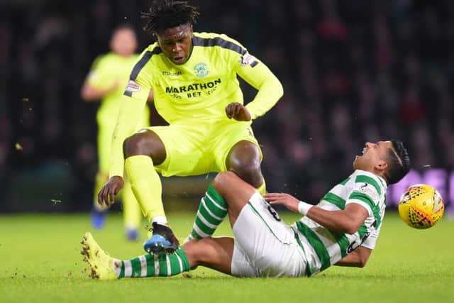 Emilio Izaguirre feels the full force of Darnell Johnson as the pair clashed late on in the game. Picture: SNS Group