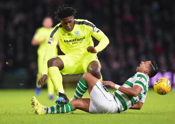 Emilio Izaguirre feels the full force of Darnell Johnson as the pair clashed late on in the game. Picture: SNS Group