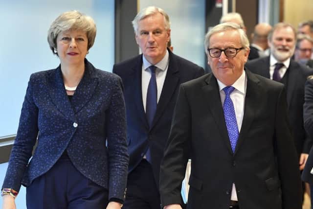 European Commission President Jean-Claude Juncker, British Prime Minister Theresa May and European Union chief Brexit negotiator Michel Barnier. Picture: AP Photo/Geert Vanden Wijngaert