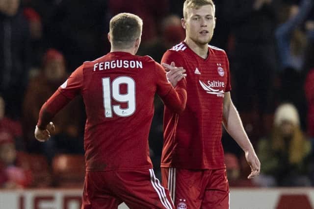 Aberdeen striker Sam Cosgrove is congratulated by Lewis Ferguson after scoring the first of his two goals against Rangers in midweek. Picture: SNS