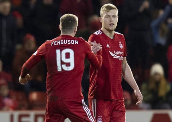 Aberdeen striker Sam Cosgrove is congratulated by Lewis Ferguson after scoring the first of his two goals against Rangers in midweek. Picture: SNS